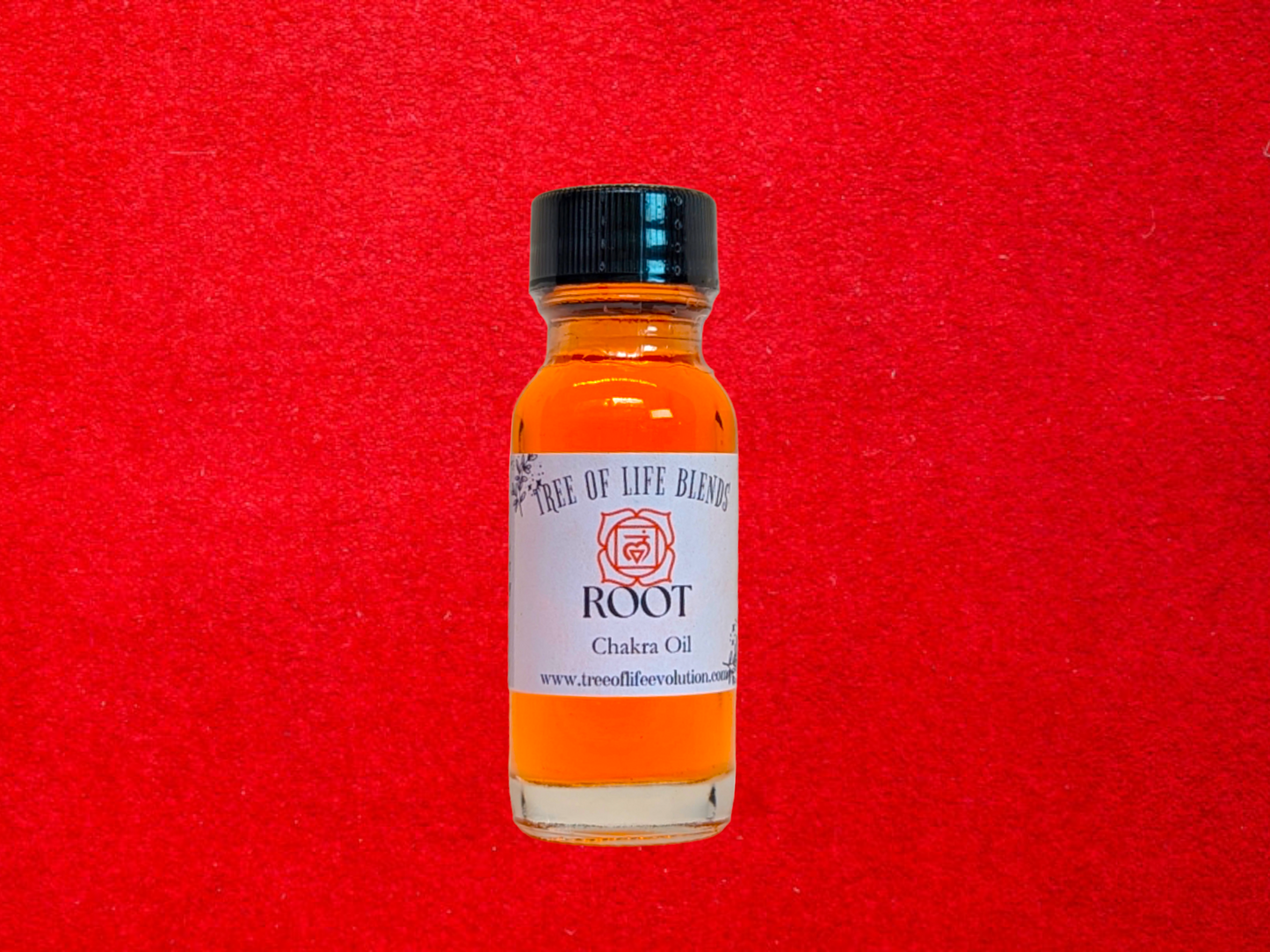 Root chakra oil from Tree of Life Evolution on red background